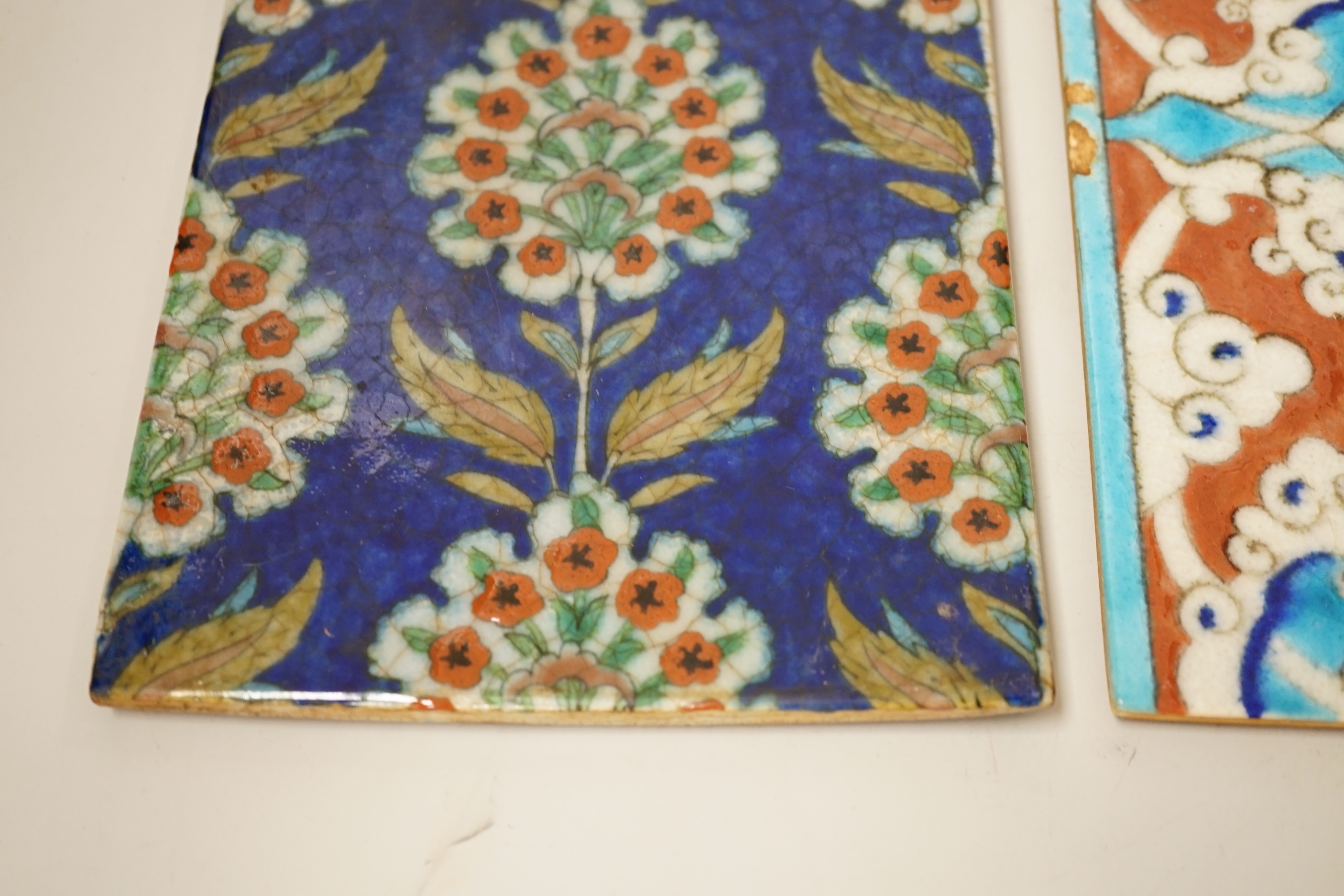Two small Turkish Iznik pottery tiles, decorated with stylised flowers, each 24cm x 16cm